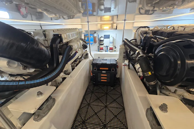 Slide: The Image of Engine room of 2006 Jersey Cape 44 Convertible yacht, showcasing dual engines and equipment. - 41