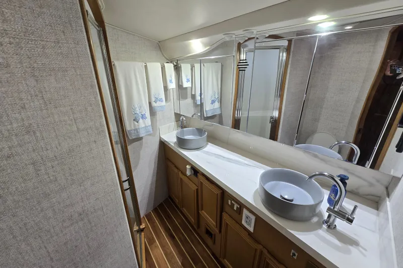 Slide: The Image of Luxurious bathroom in 2006 Jersey Cape 44 Convertible yacht with dual sinks and elegant decor. - 18