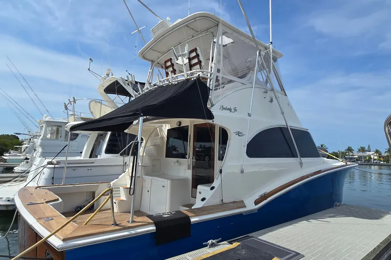 Slide: The Image of 2006 Jersey Cape 44 Convertible yacht docked, featuring sleek design and spacious deck. - 32