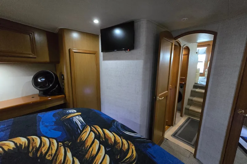 Slide: The Image of Interior of 2006 Jersey Cape 44 Convertible yacht, featuring cozy cabin and modern amenities. - 17