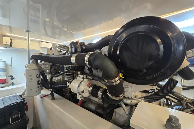 Slide: The Image of Engine room of a 2006 Jersey Cape 44 Convertible yacht, showcasing mechanical components. - 42