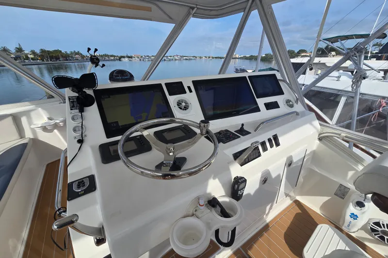 Slide: The Image of Helm of 2006 Jersey Cape 44 Convertible yacht with navigation equipment and steering wheel. - 25