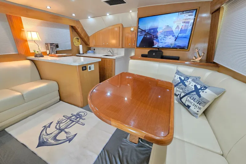 Slide: The Image of Luxurious interior of 2006 Jersey Cape 44 Convertible yacht with elegant seating and nautical decor. - 15