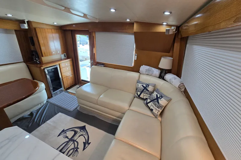 Slide: The Image of Luxurious interior of 2006 Jersey Cape 44 Convertible yacht with plush seating and nautical decor. - 14