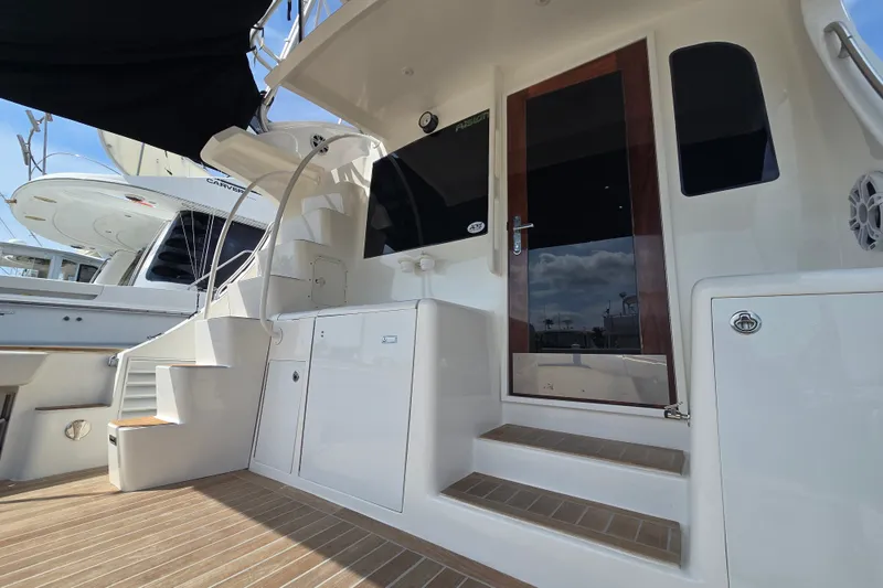 Slide: The Image of 2006 Jersey Cape 44 Convertible yacht with sleek exterior and wooden door. - 36