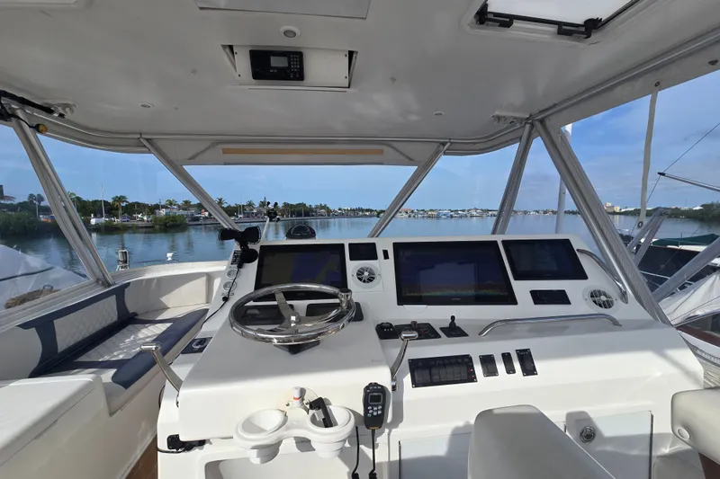 Slide: The Image of Helm of 2006 Jersey Cape 44 Convertible yacht with modern navigation equipment and scenic water view. - 26