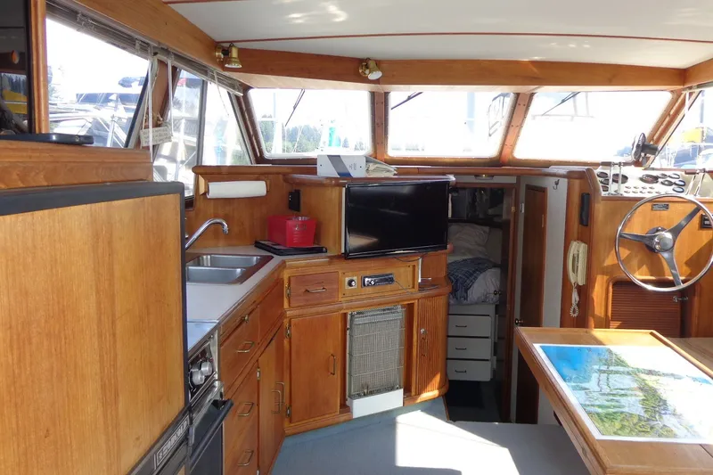 Slide: The Image of Interior of 1987 Tollycraft 34 Convertible Sedan with wood cabinetry and helm station. - 12
