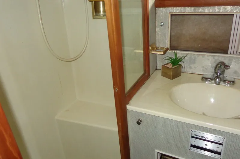 Slide: The Image of 1987 Tollycraft 34 Convertible Sedan bathroom with shower and sink. - 24