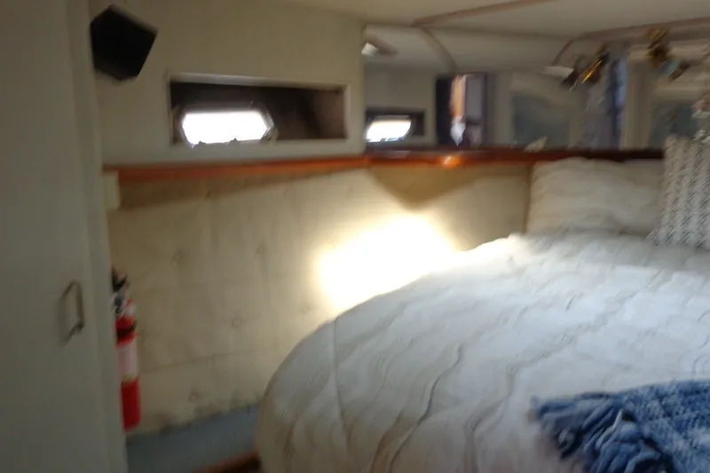 Slide: The Image of Interior of 1987 Tollycraft 34 Convertible Sedan with cozy bed and porthole window. - 19
