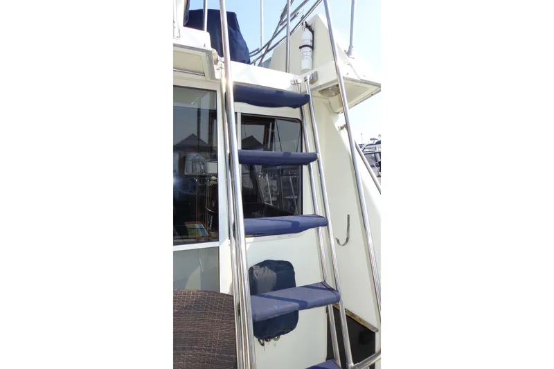 Slide: The Image of Staircase on 1987 Tollycraft 34 Convertible Sedan yacht with blue steps and metal railing. - 9