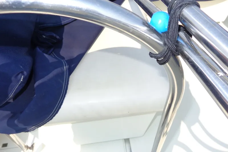 Slide: The Image of Close-up of a 1987 Tollycraft 34 Convertible Sedan's railing with blue cord detail. - 29