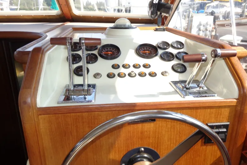 Slide: The Image of 1987 Tollycraft 34 Convertible Sedan helm with gauges and controls. - 33