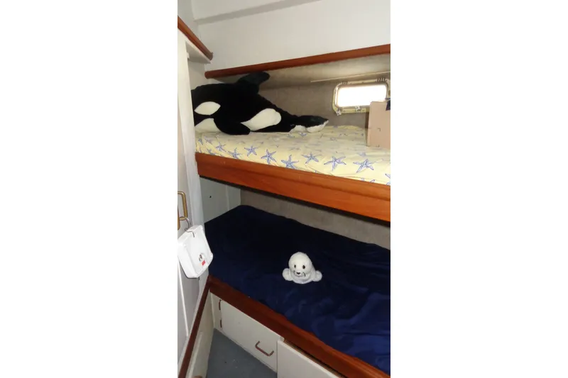 Slide: The Image of Bunk beds with plush toys in a 1987 Tollycraft 34 Convertible Sedan cabin. - 21