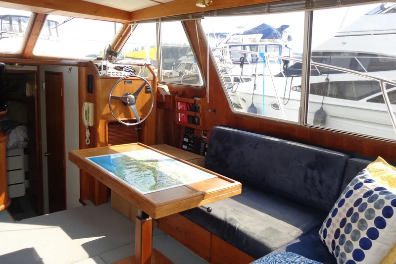 Slide: The Image of Interior of 1987 Tollycraft 34 Convertible Sedan with helm, seating, and nautical decor. - 11