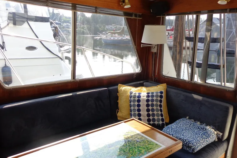 Slide: The Image of Interior of 1987 Tollycraft 34 Convertible Sedan with cozy seating and nautical decor. - 15