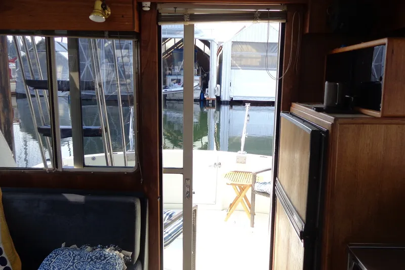 Slide: The Image of Interior view of 1987 Tollycraft 34 Convertible Sedan, overlooking marina through open door. - 16