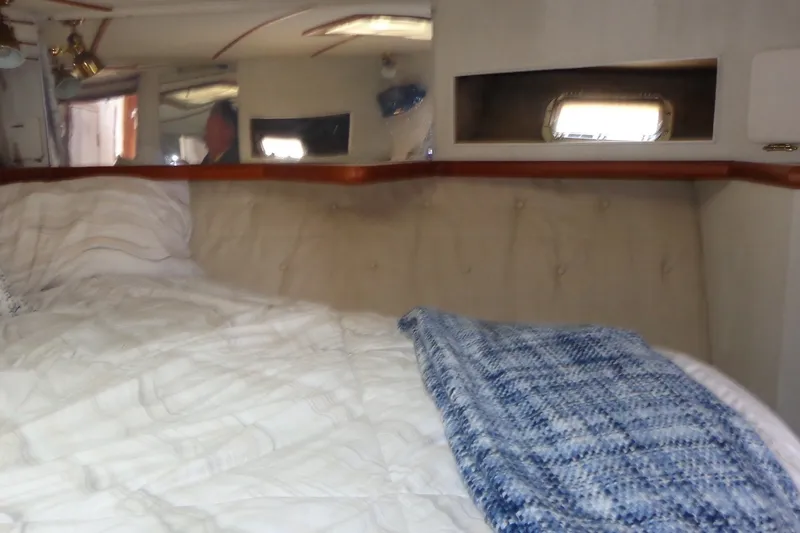 Slide: The Image of Interior cabin of 1987 Tollycraft 34 Convertible Sedan with cozy bedding and window. - 20