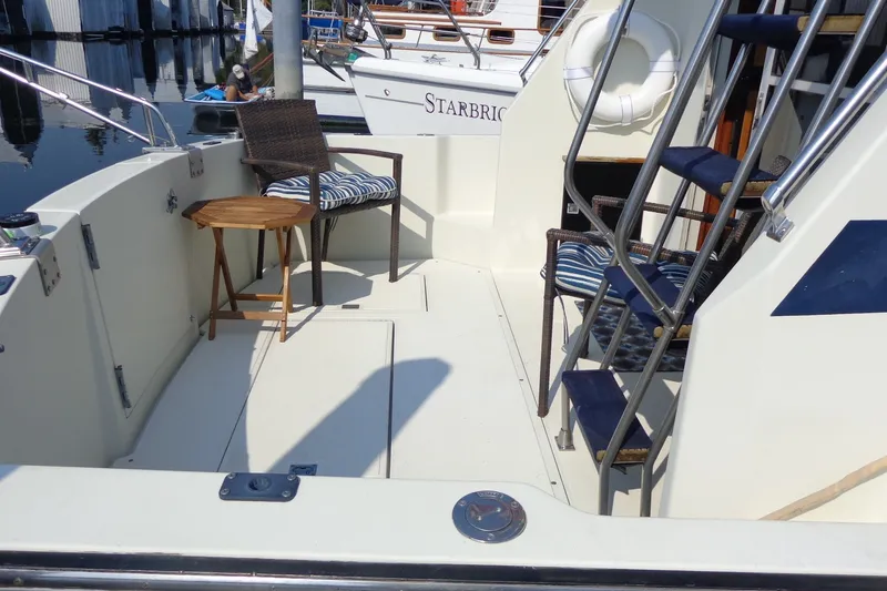 Slide: The Image of 1987 Tollycraft 34 Convertible Sedan boat deck with chairs and stairs. - 5