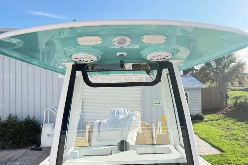 Slide: The Image of 2025 Sportsman Heritage 231 Center Console boat with teal T-top and speakers. - 39