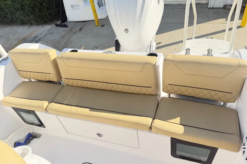 Slide: The Image of 2025 Sportsman Heritage 231 Center Console boat with tan cushioned seating and modern design. - 34