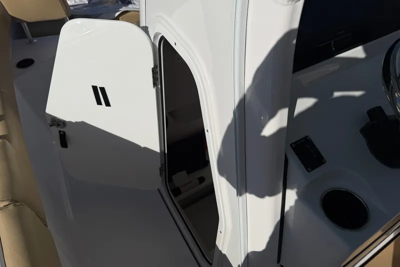 Slide: The Image of 2025 Sportsman Heritage 231 Center Console boat with open storage compartment. - 14