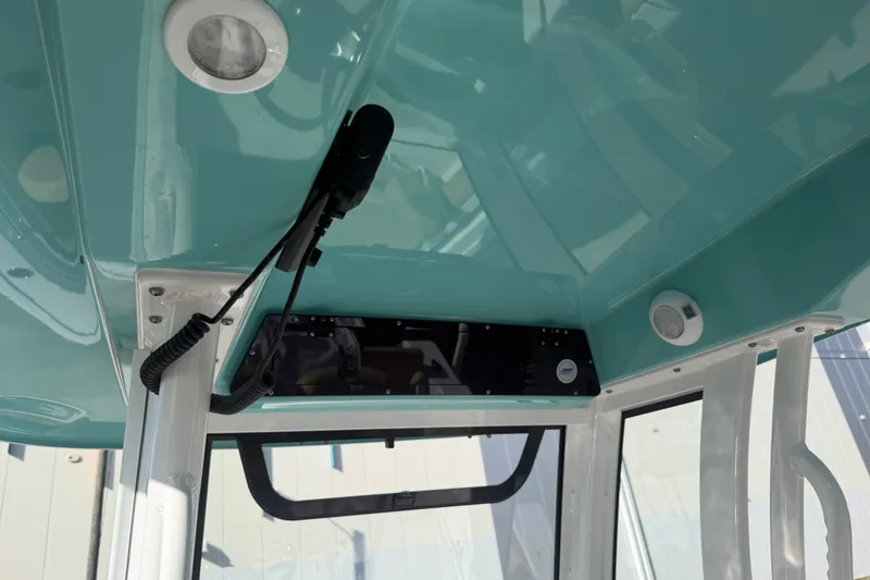 Slide: The Image of Interior view of 2025 Sportsman Heritage 231 Center Console boat, featuring teal ceiling and equipment. - 30