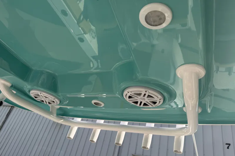 Slide: The Image of 2025 Sportsman Heritage 231 Center Console boat underside with speakers and rod holders. - 31