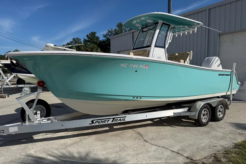 The Image of A turquoise 2025 Sportsman Heritage 231 Center Console on a trailer in front of a building. - 0