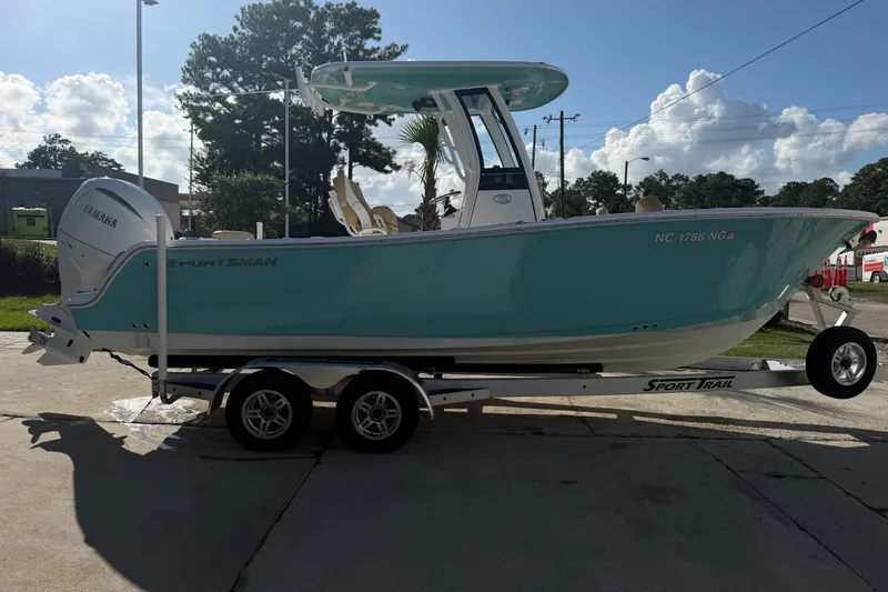 Slide: The Image of 2025 Sportsman Heritage 231 Center Console boat on trailer, parked outdoors. - 5