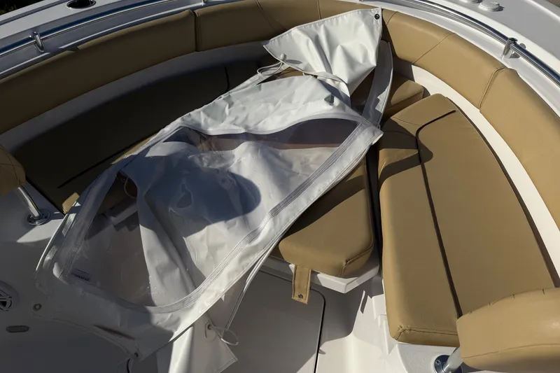 Slide: The Image of 2025 Sportsman Heritage 231 Center Console boat with tan seating and protective cover. - 28