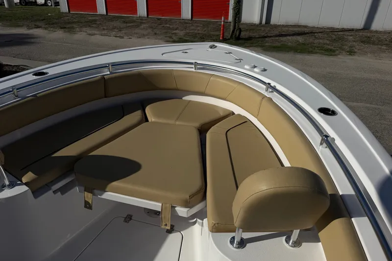 Slide: The Image of 2025 Sportsman Heritage 231 Center Console boat with tan cushioned seating in the bow area. - 17