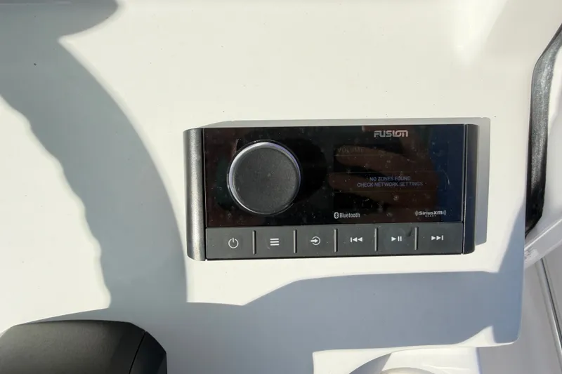 Slide: The Image of Control panel on 2025 Sportsman Heritage 231 Center Console boat, featuring Fusion audio system. - 41