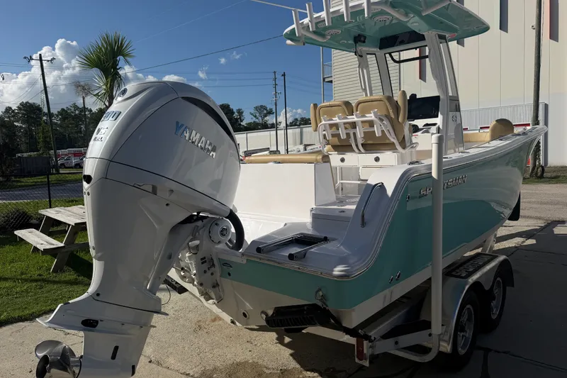 Slide: The Image of 2025 Sportsman Heritage 231 Center Console boat with Yamaha engine, parked outdoors. - 4