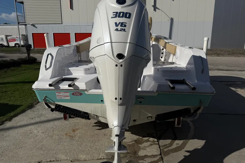 Slide: The Image of 2025 Sportsman Heritage 231 Center Console boat with powerful 300 V6 engine, docked outdoors. - 12