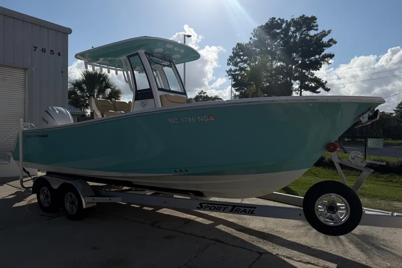 Slide: The Image of 2025 Sportsman Heritage 231 Center Console boat on trailer, parked outdoors. - 10