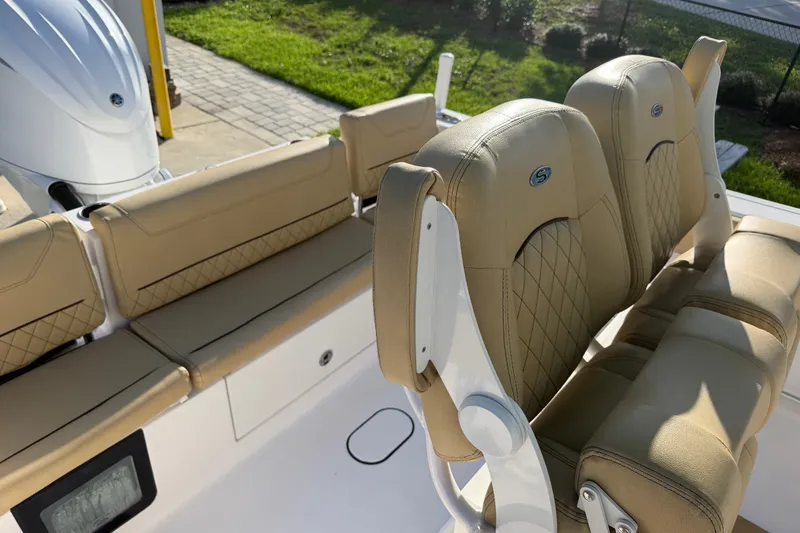 Slide: The Image of 2025 Sportsman Heritage 231 Center Console boat with tan cushioned seating. - 45