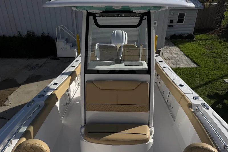 Slide: The Image of 2025 Sportsman Heritage 231 Center Console boat interior with tan seating and sleek design. - 21