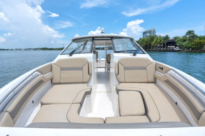Slide: The Image of 2018 Pursuit DC 365 Dual Console boat with spacious seating on a sunny day. - 34