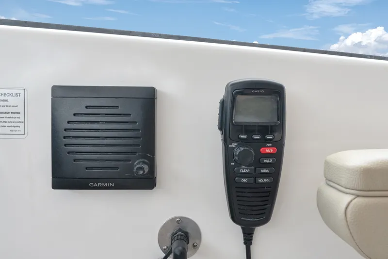 Slide: The Image of Garmin marine radio and speaker on 2018 Pursuit DC 365 Dual Console boat. - 42