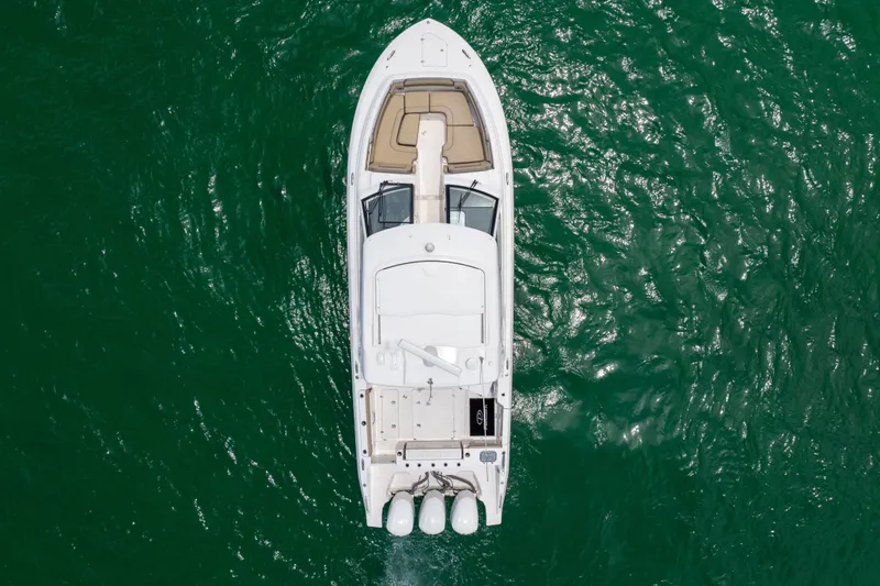 Slide: The Image of Overhead view of 2018 Pursuit DC 365 Dual Console boat on green water. - 63