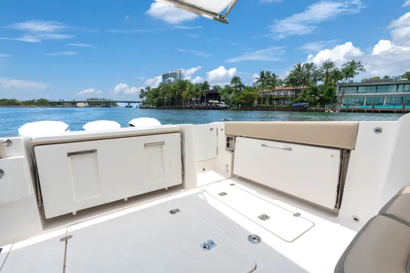 Slide: The Image of 2018 Pursuit DC 365 Dual Console boat interior with scenic waterfront view. - 22