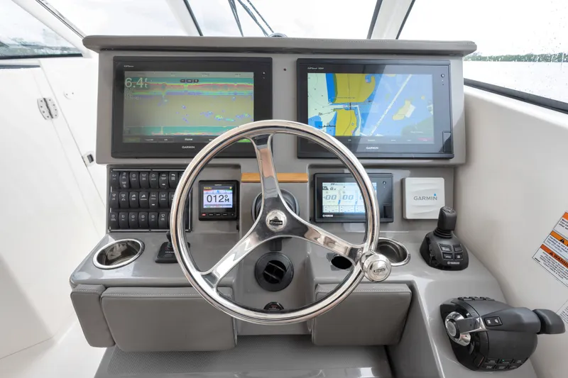 Slide: The Image of Helm of 2018 Pursuit DC 365 Dual Console with Garmin navigation displays and controls. - 39