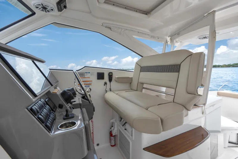 Slide: The Image of Interior of 2018 Pursuit DC 365 Dual Console boat with helm and seating. - 49