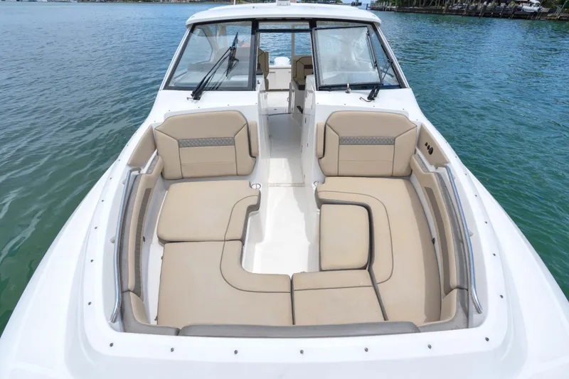 Slide: The Image of 2018 Pursuit DC 365 Dual Console boat with spacious seating on calm water. - 33