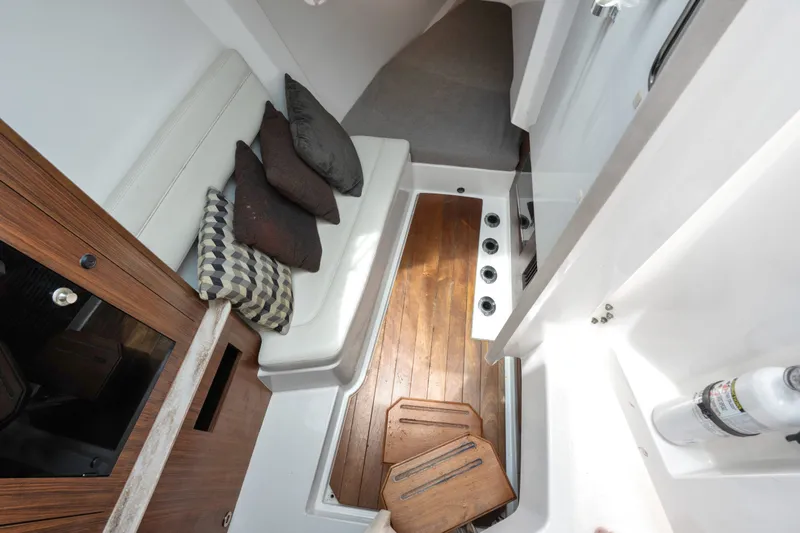 Slide: The Image of 2018 Pursuit DC 365 Dual Console interior with wooden flooring and cushioned seating. - 51