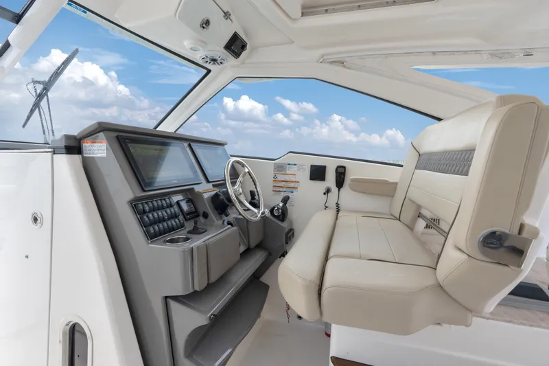Slide: The Image of 2018 Pursuit DC 365 Dual Console boat interior with modern dashboard and seating. - 48