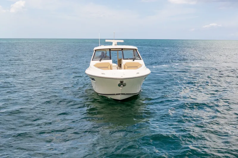 Slide: The Image of 2018 Pursuit DC 365 Dual Console boat on open sea, front view. - 13