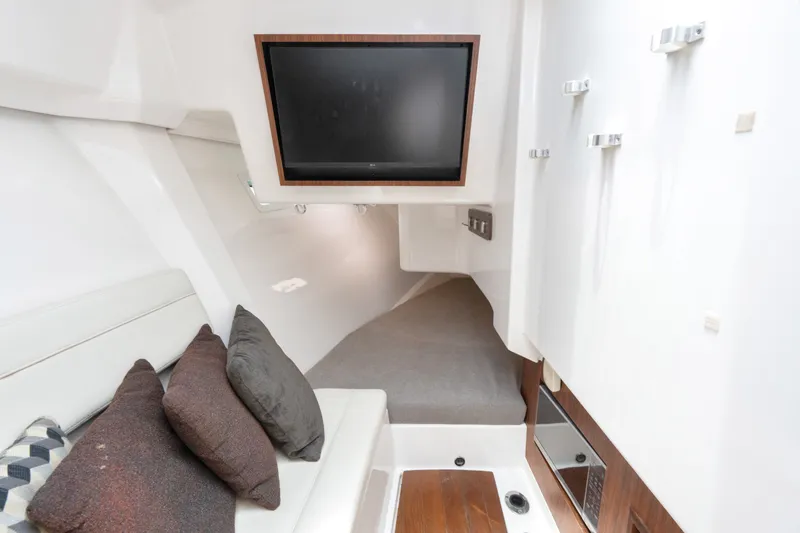 Slide: The Image of Interior of 2018 Pursuit DC 365 Dual Console boat with TV and seating area. - 52