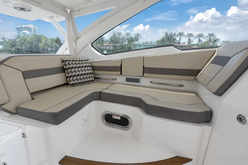 Slide: The Image of Luxurious seating area on a 2018 Pursuit DC 365 Dual Console boat, with scenic view. - 31