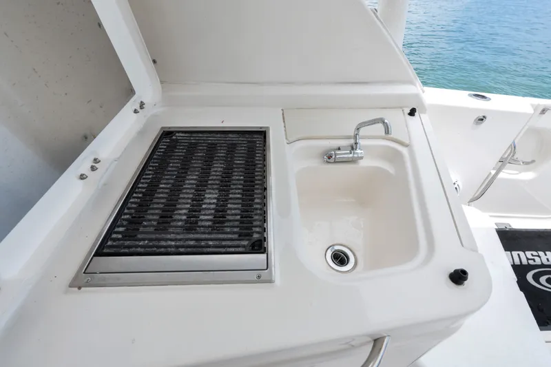 Slide: The Image of Outdoor sink and grill on 2018 Pursuit DC 365 Dual Console boat. - 24